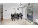 Dining room with tile flooring, a modern light fixture, and access to the patio at 5236 Krista Alethea St, North Las Vegas, NV 89031