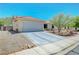 Inviting single-story home with a two-car garage and low-maintenance desert landscaping at 5236 Krista Alethea St, North Las Vegas, NV 89031