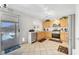 Bright kitchen featuring stainless steel appliances, light wood cabinetry, and access to the backyard patio at 5236 Krista Alethea St, North Las Vegas, NV 89031
