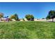 Expansive green community park with a playground, basketball court and walking path under a bright blue sky at 5236 Krista Alethea St, North Las Vegas, NV 89031