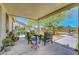 Spacious covered patio with outdoor seating, desert landscaping, and tranquil backyard view at 5236 Krista Alethea St, North Las Vegas, NV 89031