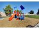 Brightly colored playground with slide and climbing structure on wood chip ground in a community park at 5236 Krista Alethea St, North Las Vegas, NV 89031