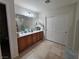 Well-lit bathroom with double sinks, tile floor, and ample counter space at 5507 Gemini Bridges St, Las Vegas, NV 89130