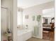 Bright bathroom with tub, shower, and an entrance to the main bedroom at 5507 Gemini Bridges St, Las Vegas, NV 89130