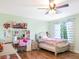 A charming bedroom for with a desk and a bed and a ceiling fan at 5507 Gemini Bridges St, Las Vegas, NV 89130