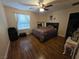 Bedroom with a comfortable bed, wood floors, and natural light at 5507 Gemini Bridges St, Las Vegas, NV 89130