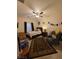 Cozy bedroom features a ceiling fan, natural light, and a comfortable rug at 5507 Gemini Bridges St, Las Vegas, NV 89130
