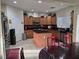 Well-equipped kitchen with wood cabinets, stainless appliances, and a center island at 5507 Gemini Bridges St, Las Vegas, NV 89130