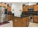 Modern kitchen with stainless steel appliances, granite countertops, and central island for meal preparation at 5507 Gemini Bridges St, Las Vegas, NV 89130