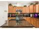 Well-equipped kitchen with stainless steel appliances, granite countertops, and ample cabinet space at 5507 Gemini Bridges St, Las Vegas, NV 89130