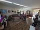 Open-concept living room featuring wood floors, stylish sofas, and a dining area at 5507 Gemini Bridges St, Las Vegas, NV 89130