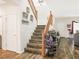 Wooden staircase featuring a carpet runner and natural lighting, creating a welcoming and stylish entry at 5507 Gemini Bridges St, Las Vegas, NV 89130
