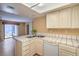 Bright kitchen with white tile counters, modern appliances, and a view to the living room at 5713 Whiteridge Ave, Las Vegas, NV 89107