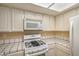 Well-lit kitchen features white cabinets, ample counter space and modern appliances at 5713 Whiteridge Ave, Las Vegas, NV 89107
