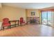 Spacious living room with a brick fireplace and sliding glass door to the backyard at 5713 Whiteridge Ave, Las Vegas, NV 89107