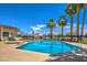 Enjoy the community's sparkling pool on a clear day, surrounded by lush palm trees and lounge chairs at 5713 Whiteridge Ave, Las Vegas, NV 89107