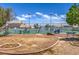 Community tennis court surrounded by landscaping, with a picnic area and park benches at 5713 Whiteridge Ave, Las Vegas, NV 89107
