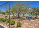 Community tennis court nestled among mature trees, featuring picnic tables and benches at 5713 Whiteridge Ave, Las Vegas, NV 89107