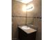 Tiled bathroom with decorative mosaic border, granite counter and undermount sink at 6196 W University Ave, Las Vegas, NV 89103