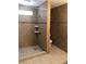 Contemporary bathroom with tiled walls, glass shower, and toilet at 6196 W University Ave, Las Vegas, NV 89103