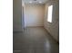Cozy bedroom with tile floors and a bright window at 6196 W University Ave, Las Vegas, NV 89103