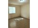 Bright bedroom with tile floor, light-filled window, and neutral walls at 6196 W University Ave, Las Vegas, NV 89103