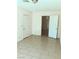 Bright bedroom with neutral walls, tile flooring, and closet space at 6196 W University Ave, Las Vegas, NV 89103