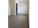 Neutral bedroom featuring tile floors and a doorway that leads to the bathroom at 6196 W University Ave, Las Vegas, NV 89103