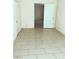 Light-filled bedroom with tile flooring and an open doorway leading to another room at 6196 W University Ave, Las Vegas, NV 89103