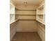 Large walk-in closet with custom shelving and rods for optimal storage at 6196 W University Ave, Las Vegas, NV 89103