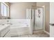 Clean bathroom with a soaking tub, shower, and white-tile surround at 628 Bay Bridge Dr, North Las Vegas, NV 89032