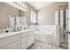 Bright bathroom featuring double sinks, a soaking tub, and a glass-enclosed shower at 628 Bay Bridge Dr, North Las Vegas, NV 89032
