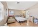 Relaxing bedroom featuring a queen-sized bed, a sitting area, and ample natural light at 628 Bay Bridge Dr, North Las Vegas, NV 89032
