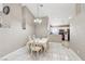 Bright dining area with white tile flooring, a dining table set for eight, and an open view to the kitchen at 628 Bay Bridge Dr, North Las Vegas, NV 89032