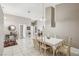 Spacious dining area with white tile flooring, a dining table set for eight, and neutral-toned walls at 628 Bay Bridge Dr, North Las Vegas, NV 89032
