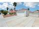 Wide shot of a home's exterior with a long driveway, two car garage, and low maintenance desert landscaping at 628 Bay Bridge Dr, North Las Vegas, NV 89032