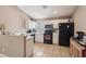 Well-lit kitchen featuring appliances, tile flooring, and white cabinetry at 628 Bay Bridge Dr, North Las Vegas, NV 89032