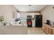 Functional kitchen featuring white cabinetry, black appliances, and a breakfast bar overlooking the sink at 628 Bay Bridge Dr, North Las Vegas, NV 89032