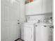 Efficient laundry room with washer, dryer, and overhead storage at 628 Bay Bridge Dr, North Las Vegas, NV 89032