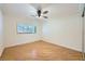 Bedroom with wood floors, ceiling fan, closet, and large window at 6315 Eldora Ave, Las Vegas, NV 89146