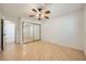 Large bedroom with wood floors, ceiling fan, and mirrored closet doors at 6315 Eldora Ave, Las Vegas, NV 89146