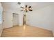 Bright bedroom with a ceiling fan, wood floors, closet, and fresh paint at 6315 Eldora Ave, Las Vegas, NV 89146