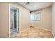 Bedroom with tiled floor, ensuite bathroom, and plantation shuttered window at 6315 Eldora Ave, Las Vegas, NV 89146