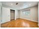 Bedroom with wood floors, closet, and window with plantation shutters at 6315 Eldora Ave, Las Vegas, NV 89146