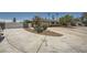 Wide driveway leading to a beautiful home with lush landscaping and mature trees at 6315 Eldora Ave, Las Vegas, NV 89146