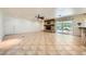 Large living room with tile flooring, stone fireplace, and sliding glass doors to patio at 6315 Eldora Ave, Las Vegas, NV 89146