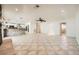 Open concept living room and kitchen area with tile flooring and stone accents at 6315 Eldora Ave, Las Vegas, NV 89146