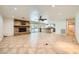 Expansive living room with stone fireplace, open kitchen view, and tile flooring at 6315 Eldora Ave, Las Vegas, NV 89146