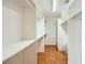 Walk-in closet with custom shelving and wood floor at 6315 Eldora Ave, Las Vegas, NV 89146