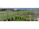A well manicured backyard featuring a dark iron fence and mountain views in the distance at 641 Majestic Rim Dr, Henderson, NV 89012